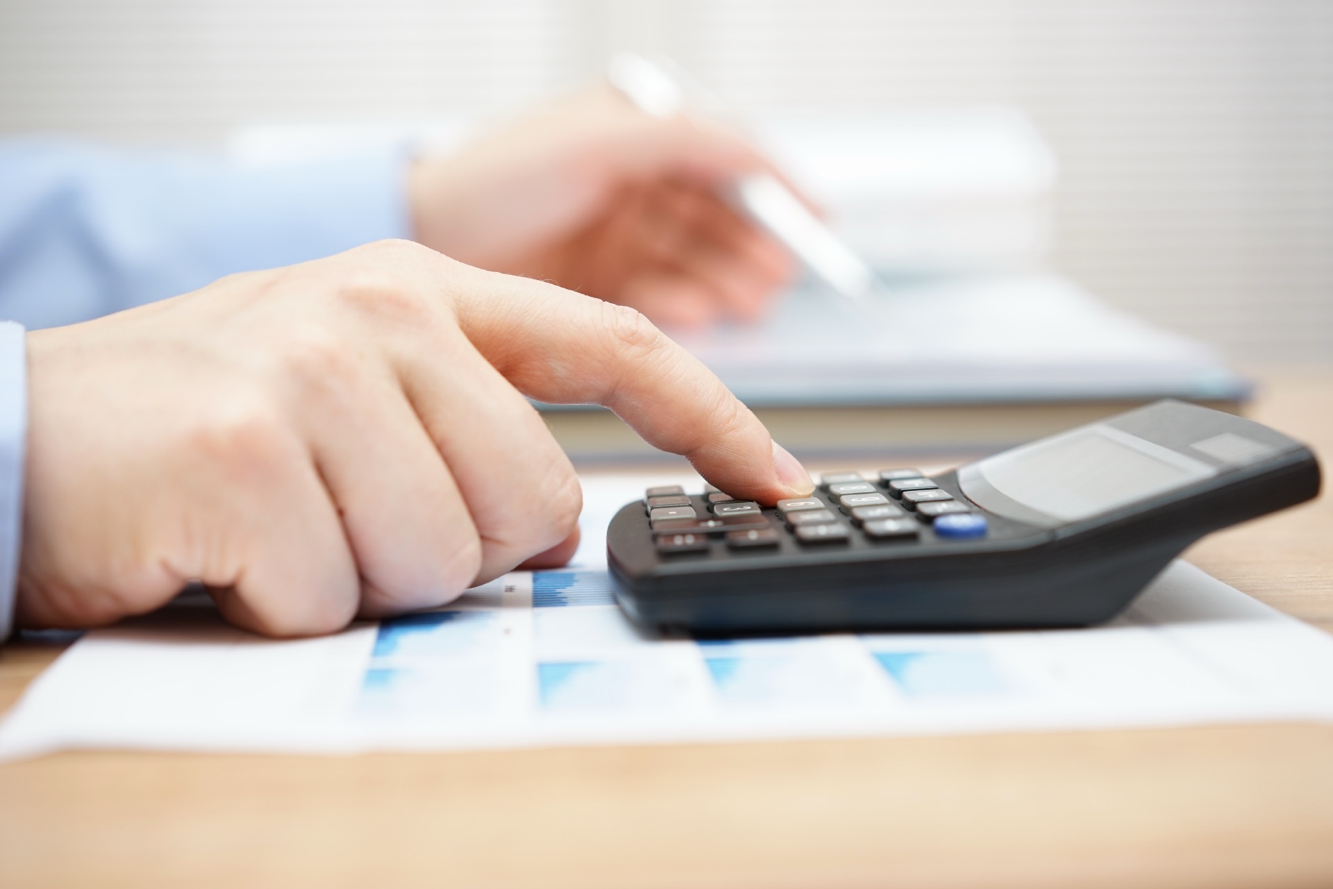 Reviewing a client's utility bills with a calculator