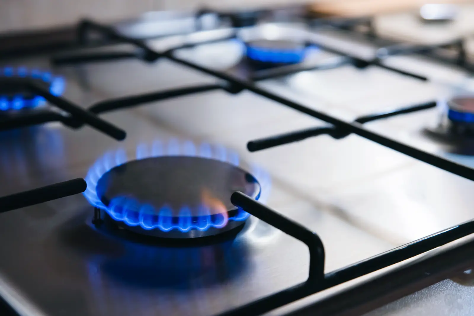 Blue gas flames burning on a commercial hob