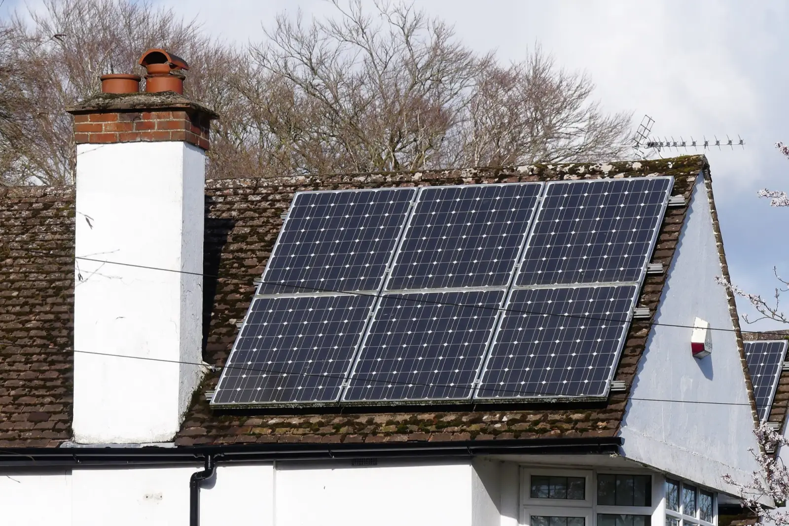 A six-panel solar installation on a tiled house roof